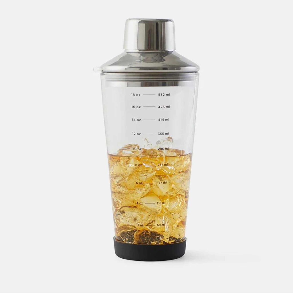 Glass cocktail shaker with measurements in ounces and milliliters.