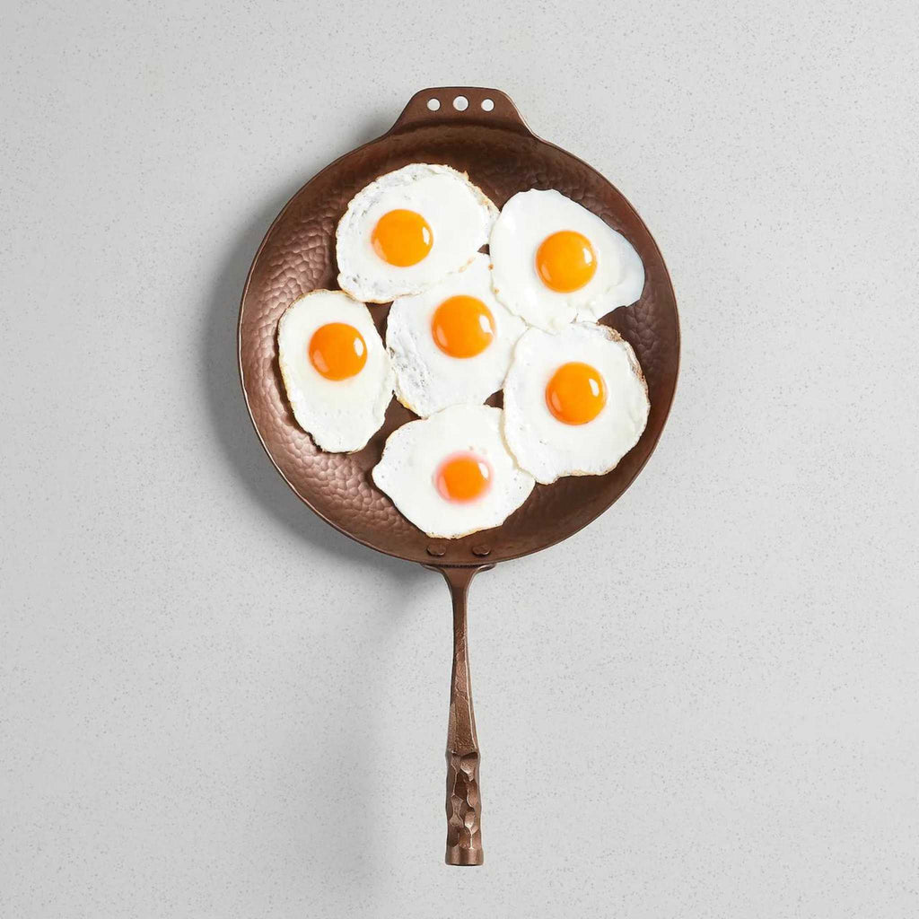 Smithey carbon steel farmhouse skillet. Lifestyle image view with fried eggs. 