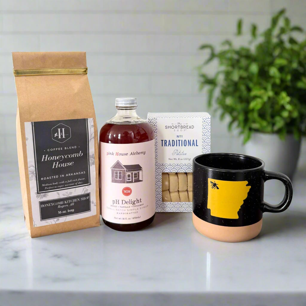 corporate gift includes 16 oz. coffee bag, ph delight simple syrup, shortbread cookies, and black mug with Arkansas shape in yellow with bee over NWA